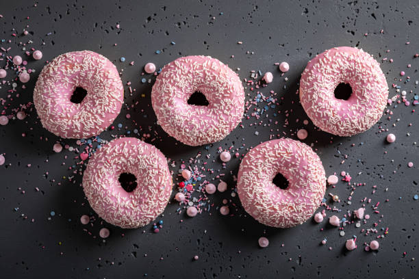 istock Homemade and delicious pink donuts for Fat Thursday 1353086601
