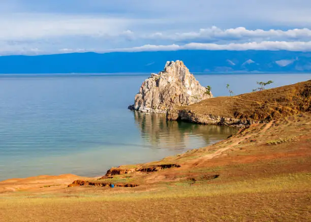 Shamanka or Shamans Rock on Baikal lake near Khuzhir at Olkhon island in Siberia, Russia. Lake Baikal is the largest freshwater lake in the world.