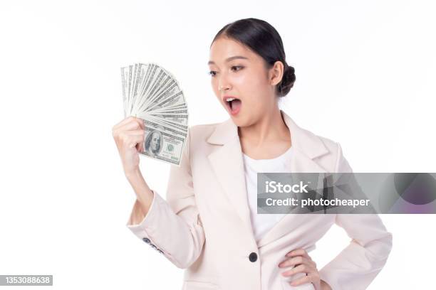 Portrait Of A Beautiful Young Asian Woman In Suit Holding Dollar Money Banknotes Money Exchange Service Studio Shot Isolated On White Background Stock Photo - Download Image Now