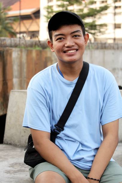 istock asian man smiling with street background 1353091215