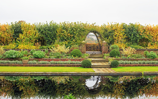 Sunken Landscaped Gardens with a lake, and good reflection of the garden. Kensington Palace, London, UK, 2021