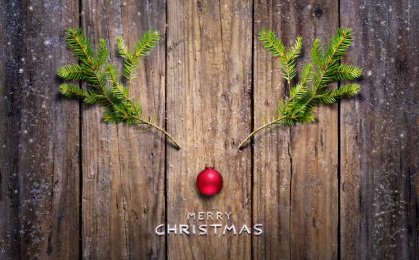 Merry Christmas - Christmas Concept - Reindeer And Pine Branches On Vintage Wooden Table
