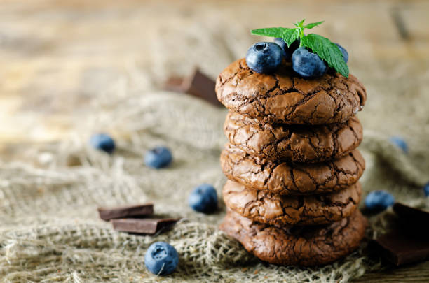 istock Chocolate brownie cookies with berries and mint leaves 1353095022