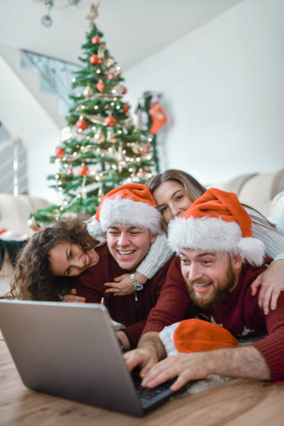 istock Laptop Fun For Christmas Celebrating Friends Near Tree 1353096844