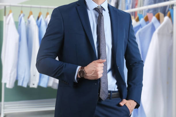 Businessman and rack with clean clothes at dry-cleaner's, closeup Businessman and rack with clean clothes at dry-cleaner's, closeup dry cleaner stock pictures, royalty-free photos & images