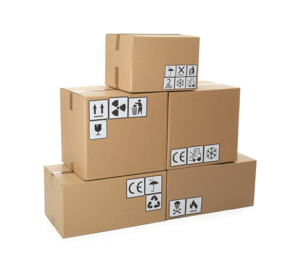 istock Stack of cardboard boxes with different packaging symbols on white background. Parcel delivery 1353097946