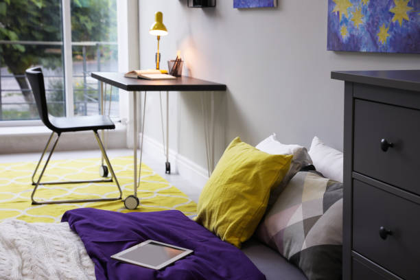istock Modern teenager's room interior with comfortable bed, workplace and stylish design elements 1353098164