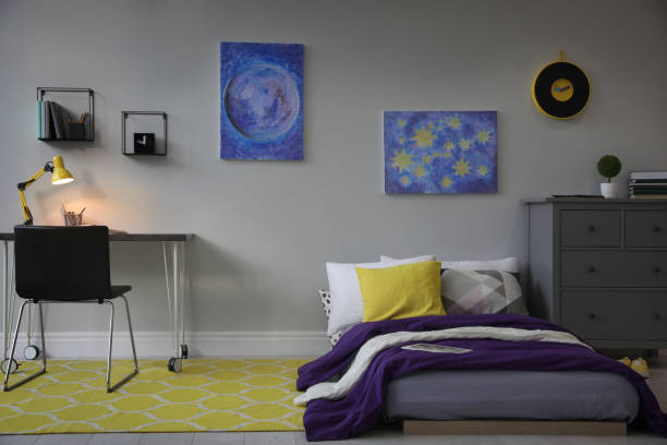 istock Modern teenager's room interior with comfortable bed, workplace and stylish design elements 1353098900