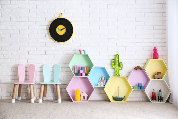 istock Child room interior with colorful shelves near brick wall 1353099433