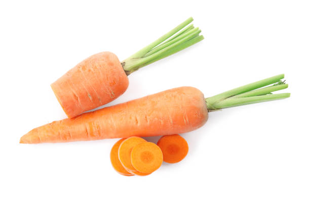 istock Whole and cut ripe carrots isolated on white, top view 1353100688