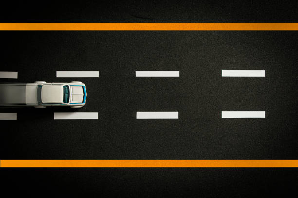 istock Top view of tiny model car speeding on black highway. 1353105578
