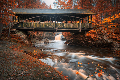 covered bridge amincon falls in fall in wisconsin