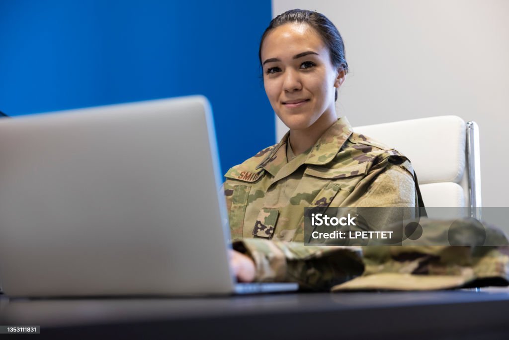 Air Force Military member in an office A female Air Force Military member in the office with a computer US Military Stock Photo