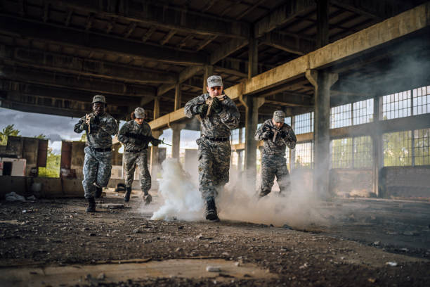 istock Soldiers with shotguns running through smoke 1353112065