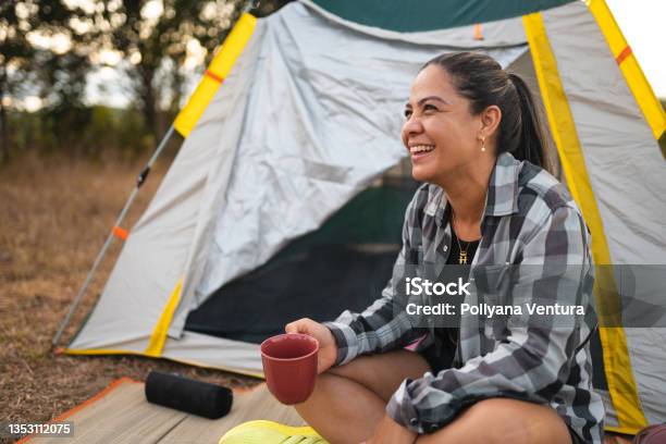 Woman Drinking Coffee At Camp In Forest Stock Photo - Download Image Now - Camping, Entertainment Tent, Tent