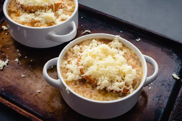 Bowls of French onion soup on a sheet pan
