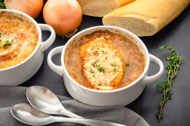 Bowls of French onion soup garnished with fresh thyme