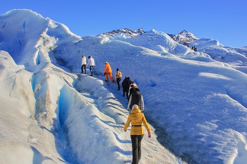Group of hiker people making amazing trekking at ice surface of melting Perito Moreno Glacier, Los Glaciares National Park, Santa Cruz Province, Patagonia Argentina, Apr.2015