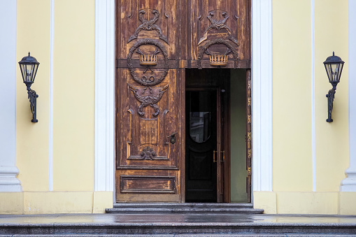 Wintage front doors with crowns. Gate of Mercy in the Catholic Church of St. Catherine in St. Petersburg, Russia