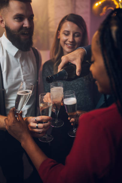 istock Friends celebrate New Year's Eve while drinking champagne 1353124102