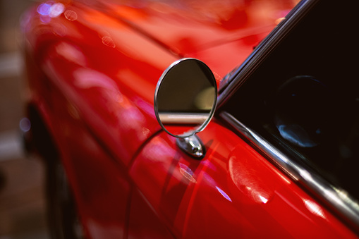 Izmir, Turkey - June 21, 2021: Close up shot of a Peugeot 204 red car side mirror which produced in France between 1965 and 1976 years. Editorial Shot in Izmir Turkey.