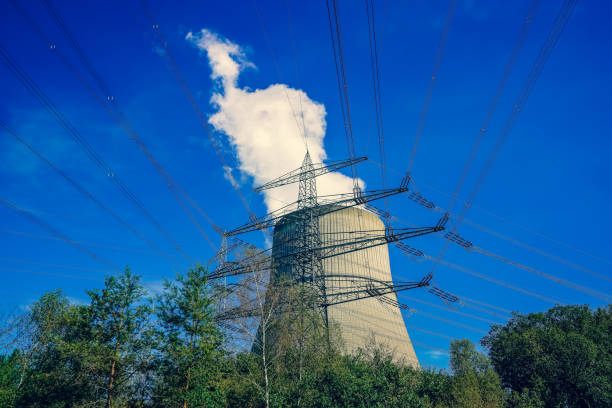 istock A power pole and nuclear power plant with beautiful sky. 1353129247