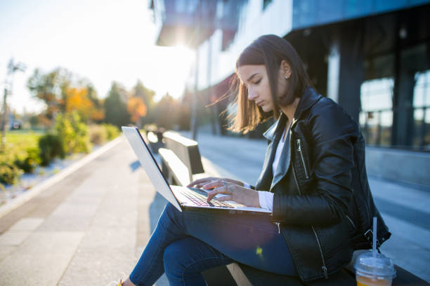 istock Young student girl using laptop at the university 1353134232