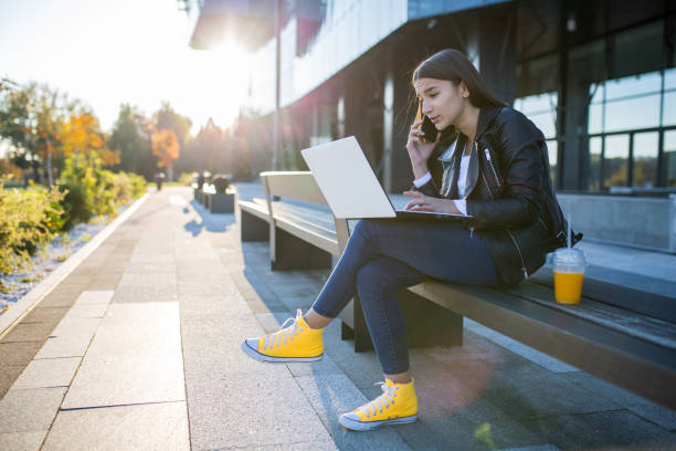 istock Young student girl using laptop at the university 1353134855