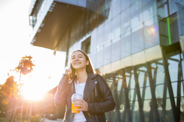 istock Trendy young female student with mobile phone 1353138047