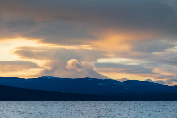 istock Landscape with stunning coloured sunset clouds above mountains. 1353138180