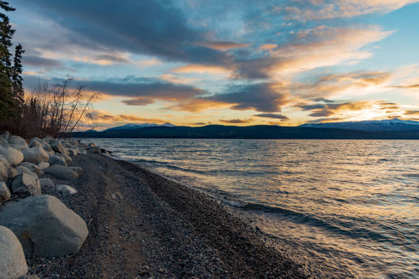 istock Rocky lakeshore sunset landscape scenic view. 1353138705