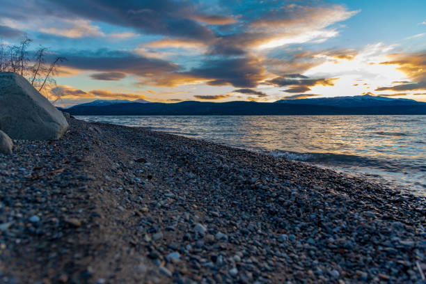 istock Rocky lakeshore sunset landscape scenic view. 1353138711