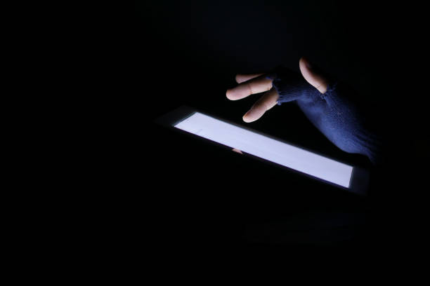 istock Close up of hacker hand stealing data from digital tablet 1353138774