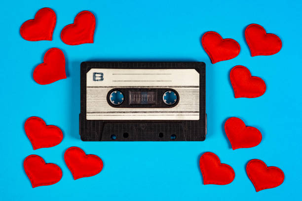 Old Audio Cassette Old Audio Cassettes with a Red Hearts on the Blue Paper Background closeup mix tape heart stock pictures, royalty-free photos & images