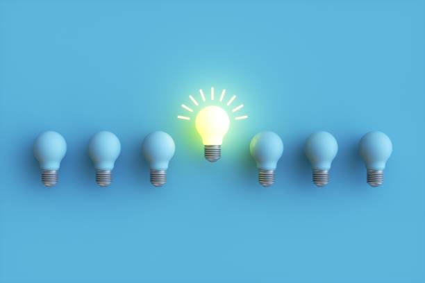 istock Creative idea and innovation Yellow light bulb symbol on blue background, brainstorming for inspiration concept 1353159373