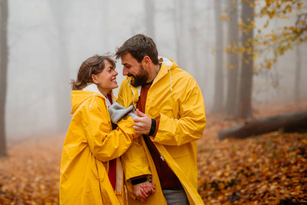 istock Couple holding hands in a forest 1353159397