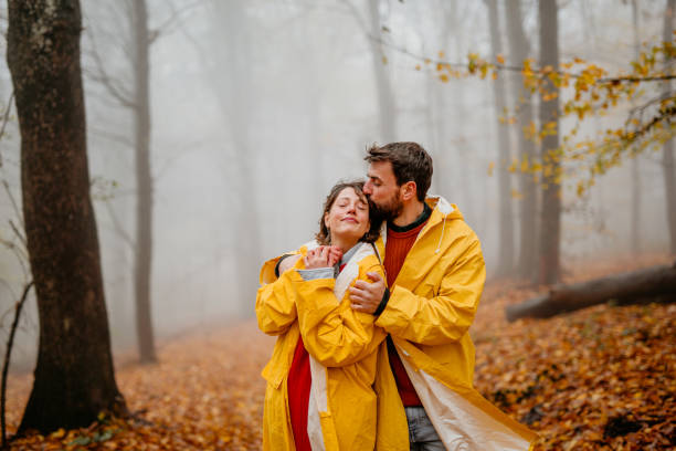 istock Couple in a raincoats having an adventure 1353159478