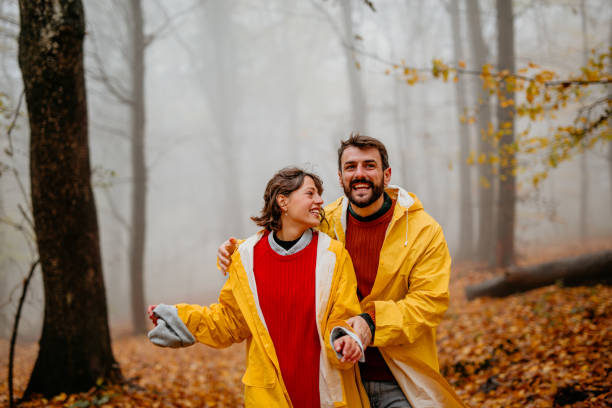 istock Couple in a raincoats having an adventure 1353159493