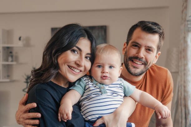 portrait of young family with toddler stock photo