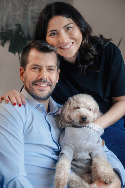 istock Young family looking at camera with their dog 1353163364