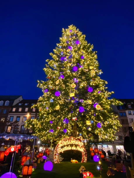istock Illuminated christmas tree at christmasmarketin Strasbourg 1353164413