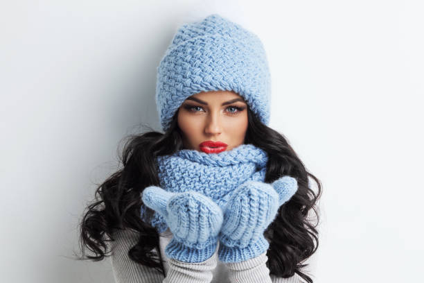 istock Winter woman blowing on palms 1353167693