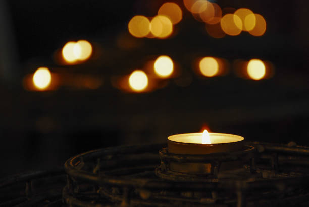 istock Burning candle with vintage bronze candlestick with dark background 1353169432