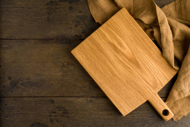 istock Bamboo lightweight cutting board above food background, napkin, horizontal, copy space 1353169683
