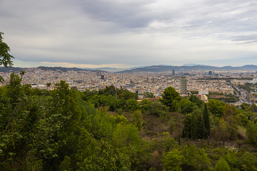 Aerial view of the city of Barcelona, Spain. Cloudscape cityscape from above. Panoramic city view. Barcelona aerial, wide angle view of the city skyline and urban grid. View from Parc Montjuic
