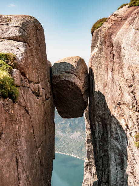istock Kjeragbolten, the stone stuck between two rocks 1353170396