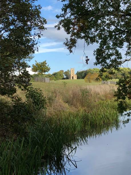 Church through trees with water