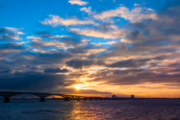 istock Bridge at sunrise. Beautiful sunrise or sunset scenery view on river bridge silhouette 1353170636
