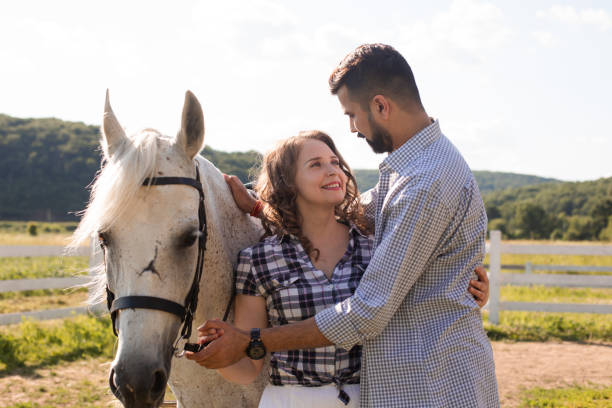 istock Young Couple Standing In Horse 1353177079