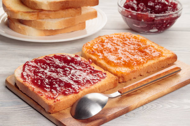 istock Toasts with jam on wooden board. Selective focus. 1353178100